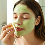 **Prompt:** A woman applying a homemade honey and yogurt face pack in a bright, natural light-filled bathroom. Focus on the creamy texture of the pack and the woman's relaxed expression. The background should subtly feature other DIY beauty ingredients like avocado and green tea powder.